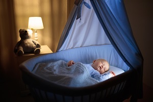 baby sleeping in pram bassinet