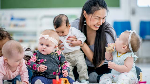 Mum holding a baby at a Bumps and Babies group