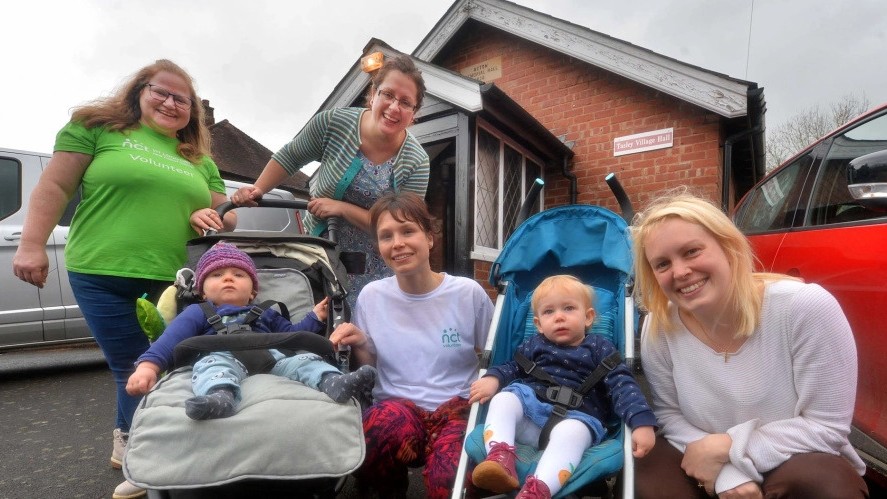 Two volunteers with parents on a Walk and Talk