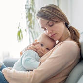 mum with baby looking worried