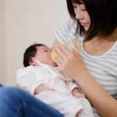 Mum bottle feeding baby