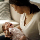 Mother holding crying baby