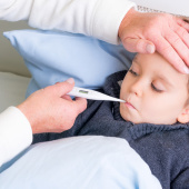 boy lying in bed unwell