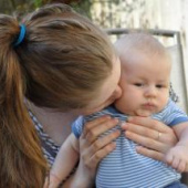 Mum kissing baby