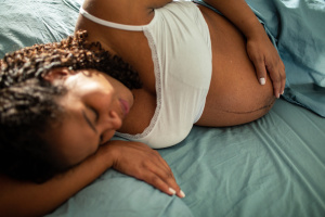 Pregnant woman lying down on her side