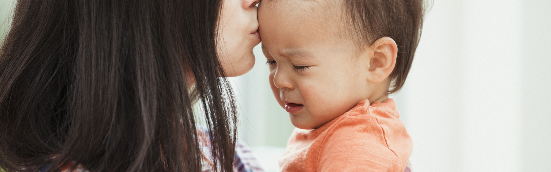 Parent kissing baby