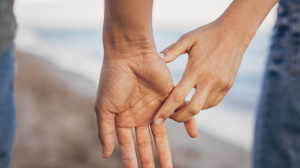 Couple holding hands on beach