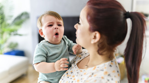 Parent holding a coughing baby