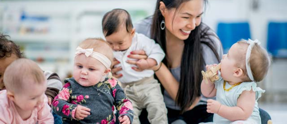 Mum holding a baby at a Bumps and Babies group